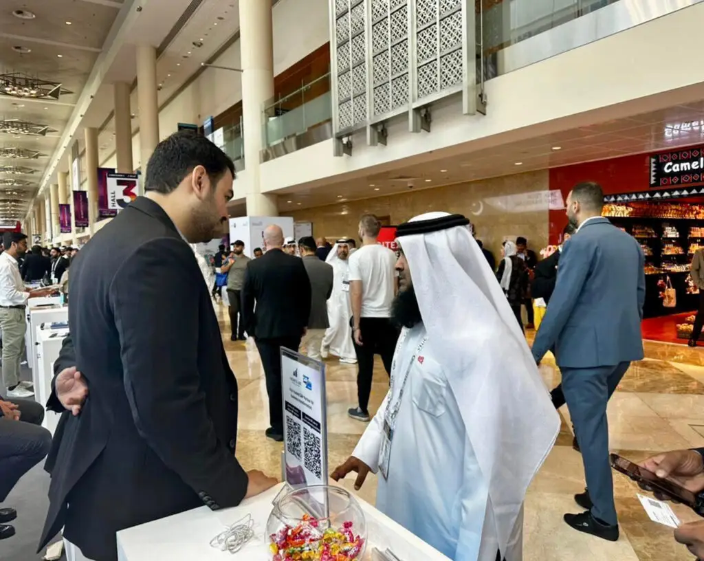 Business Line SAP Company Director Hazik discussing partnership with client at Gitex Global Booth